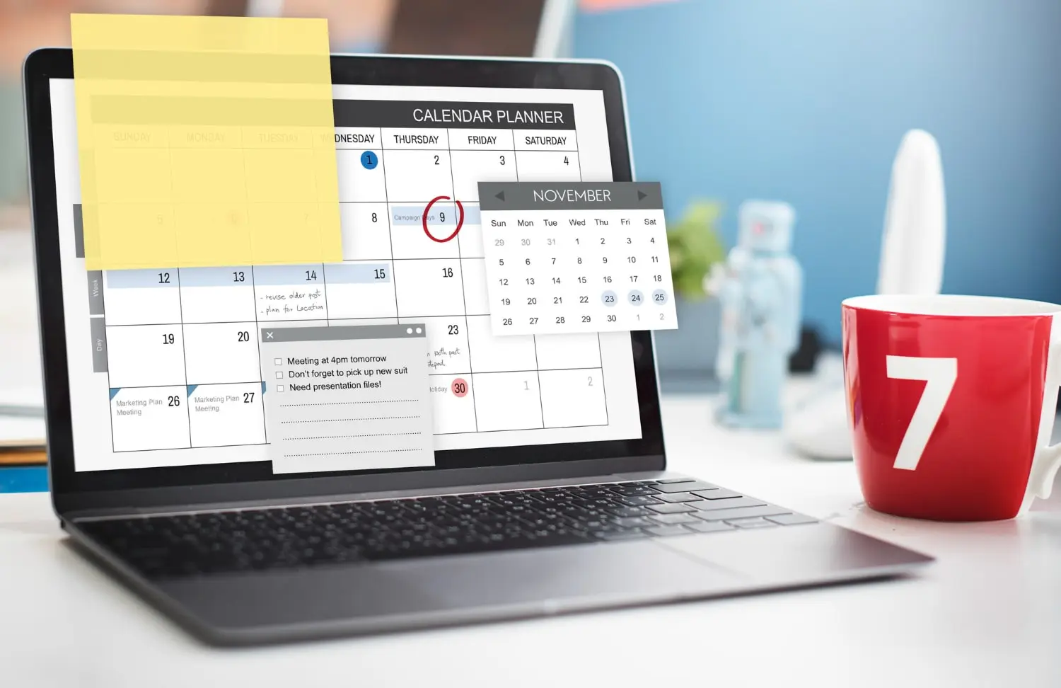 A reminder software displayed on the laptop screen on the table with a red mug next to it with 7 number on it